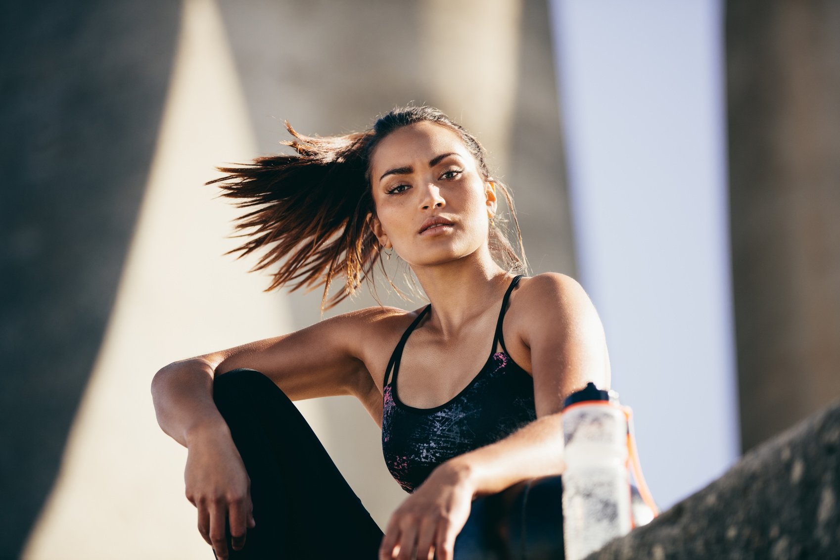 Fit Woman Sitting Outdoors After Workout Session